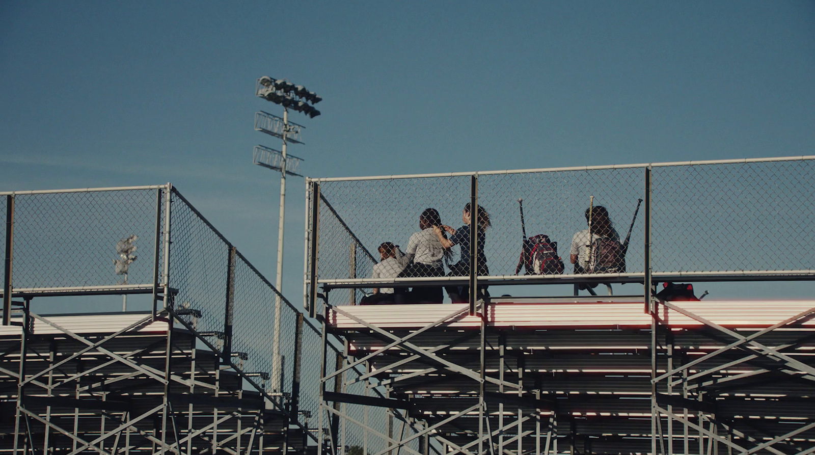 a group of people standing on top of a baseball field