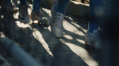 a group of people walking down a sidewalk