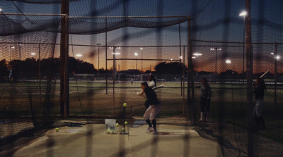 a baseball player swinging a bat at a ball