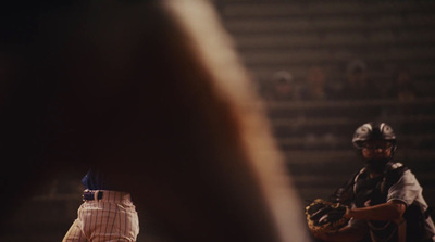 a baseball player holding a catchers mitt on a field