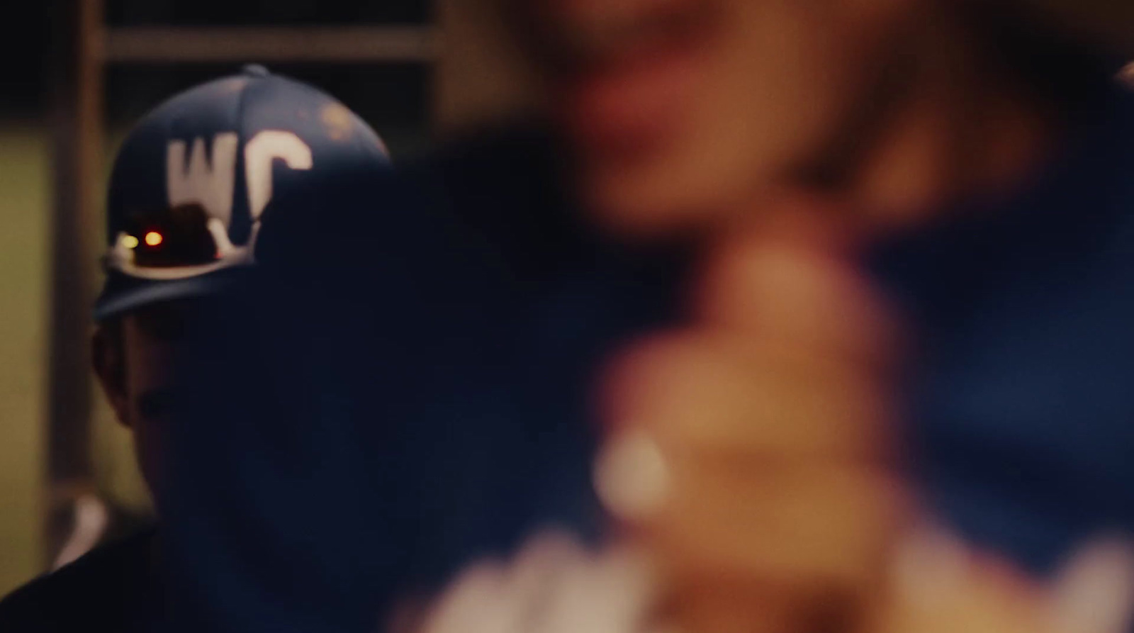 a baseball player wearing a blue hat and holding a bat