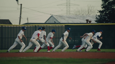 a group of baseball players running across a field