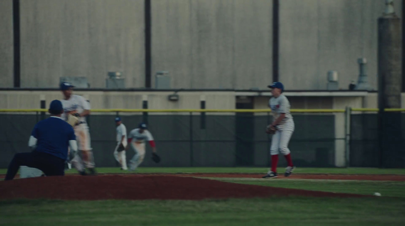 a group of baseball players standing on top of a field