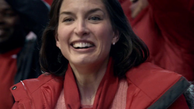 a woman in a red jacket is smiling