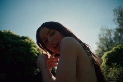 a woman is posing for a picture in the sun