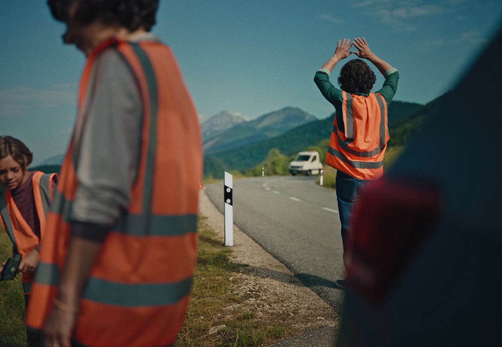 a group of people standing on the side of a road