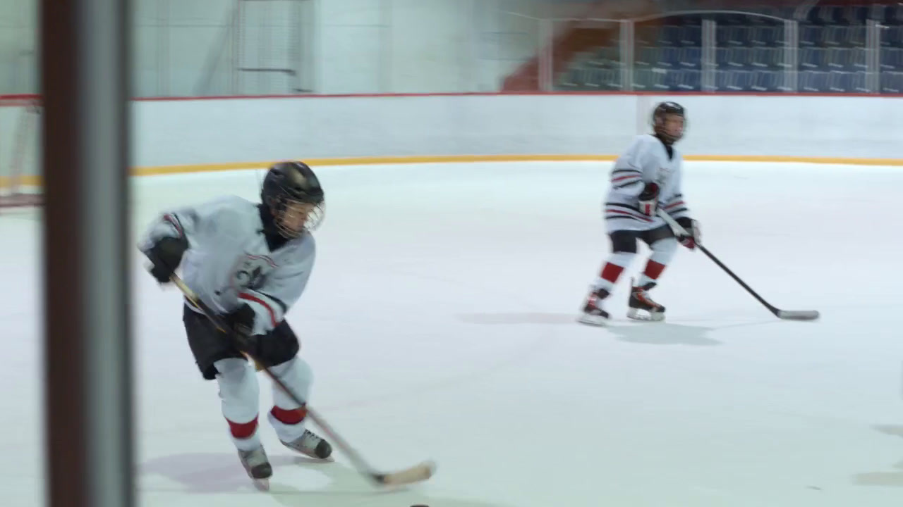 a group of young men playing a game of ice hockey