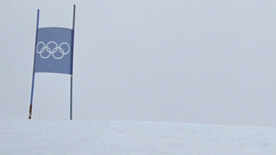 a person on skis jumping over a flag