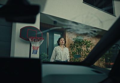 a woman standing in front of a basketball hoop