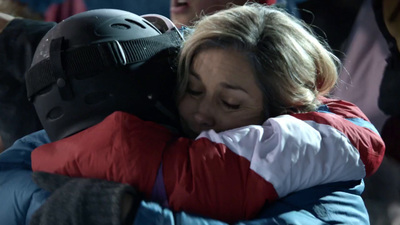 a woman hugging another woman in a crowd