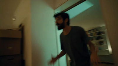 a man with a beard standing in a room