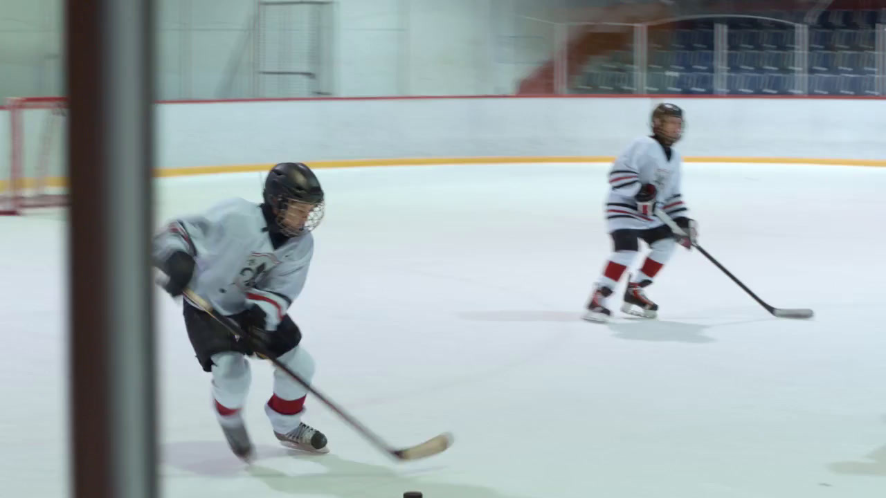 a group of young men playing a game of ice hockey