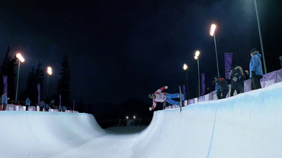 a person on a snowboard doing a trick on a ramp