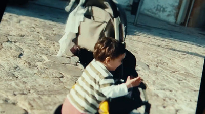 a little boy sitting on the ground with a backpack