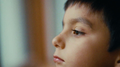 a close up of a child's face with a blurry background