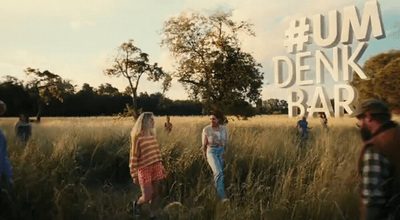 a group of people standing in a field