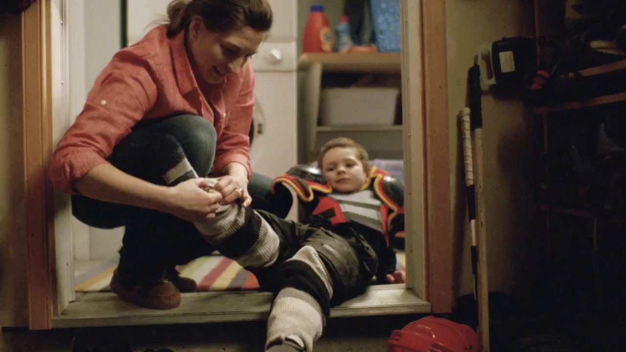 a woman kneels on the floor as a child sits on the floor