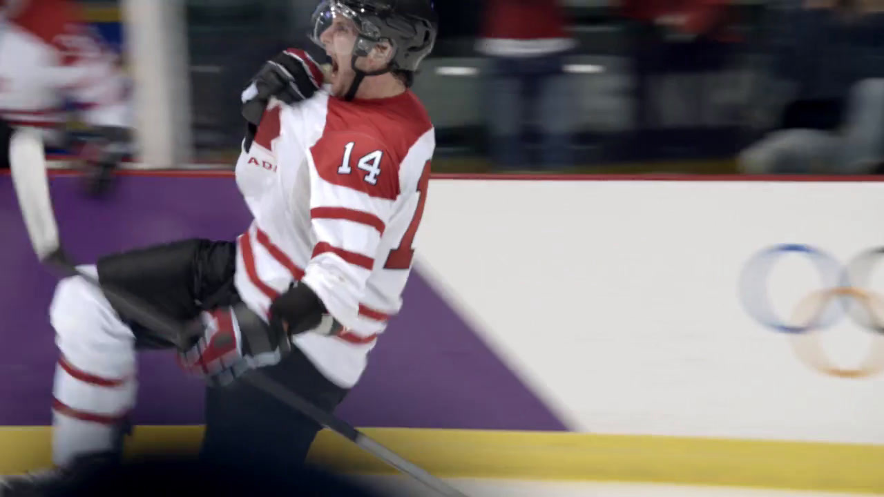 a man in a red and white uniform holding a hockey stick