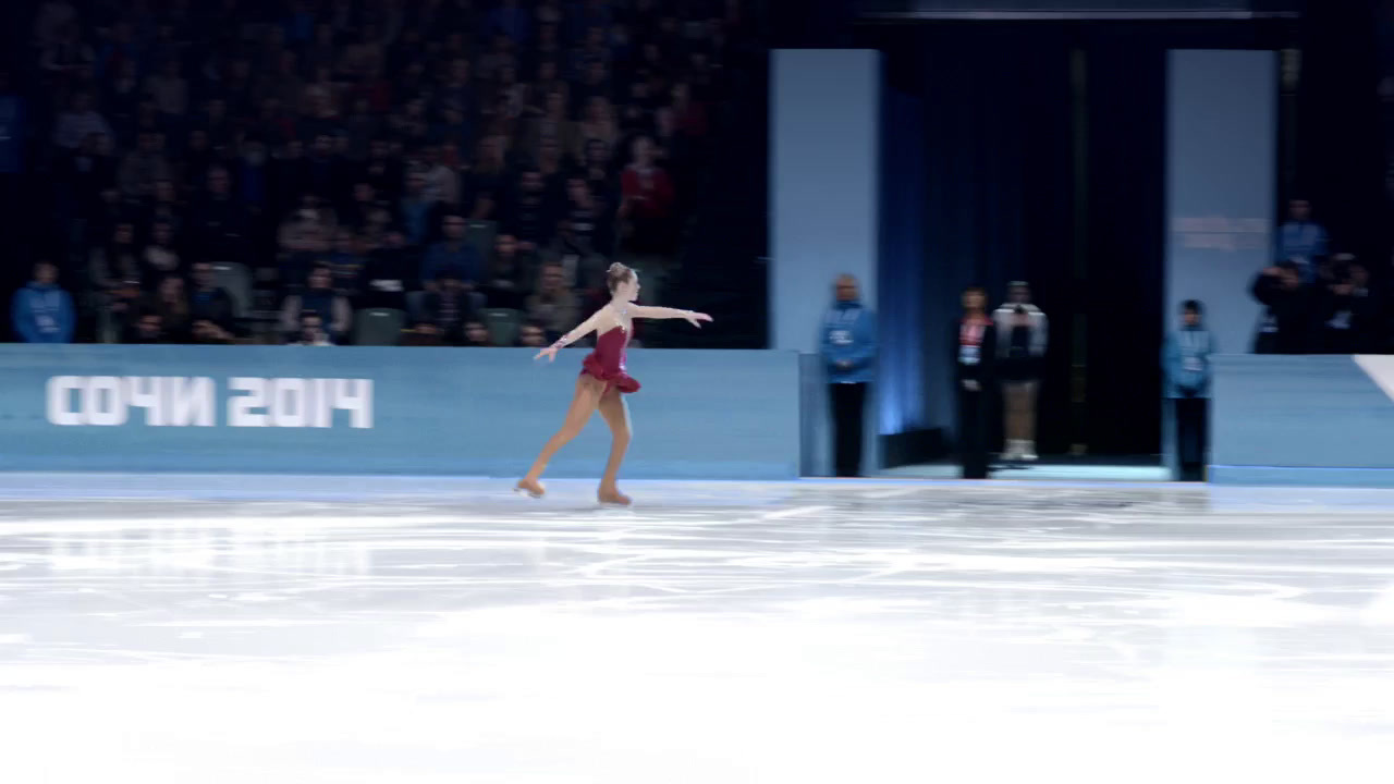 a female figure skating on an ice rink