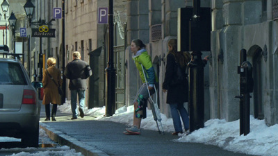 a group of people walking down a snow covered street