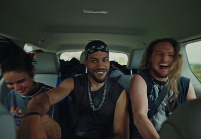 a group of men riding in the back of a car