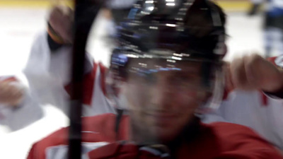 a close up of a hockey player wearing a helmet