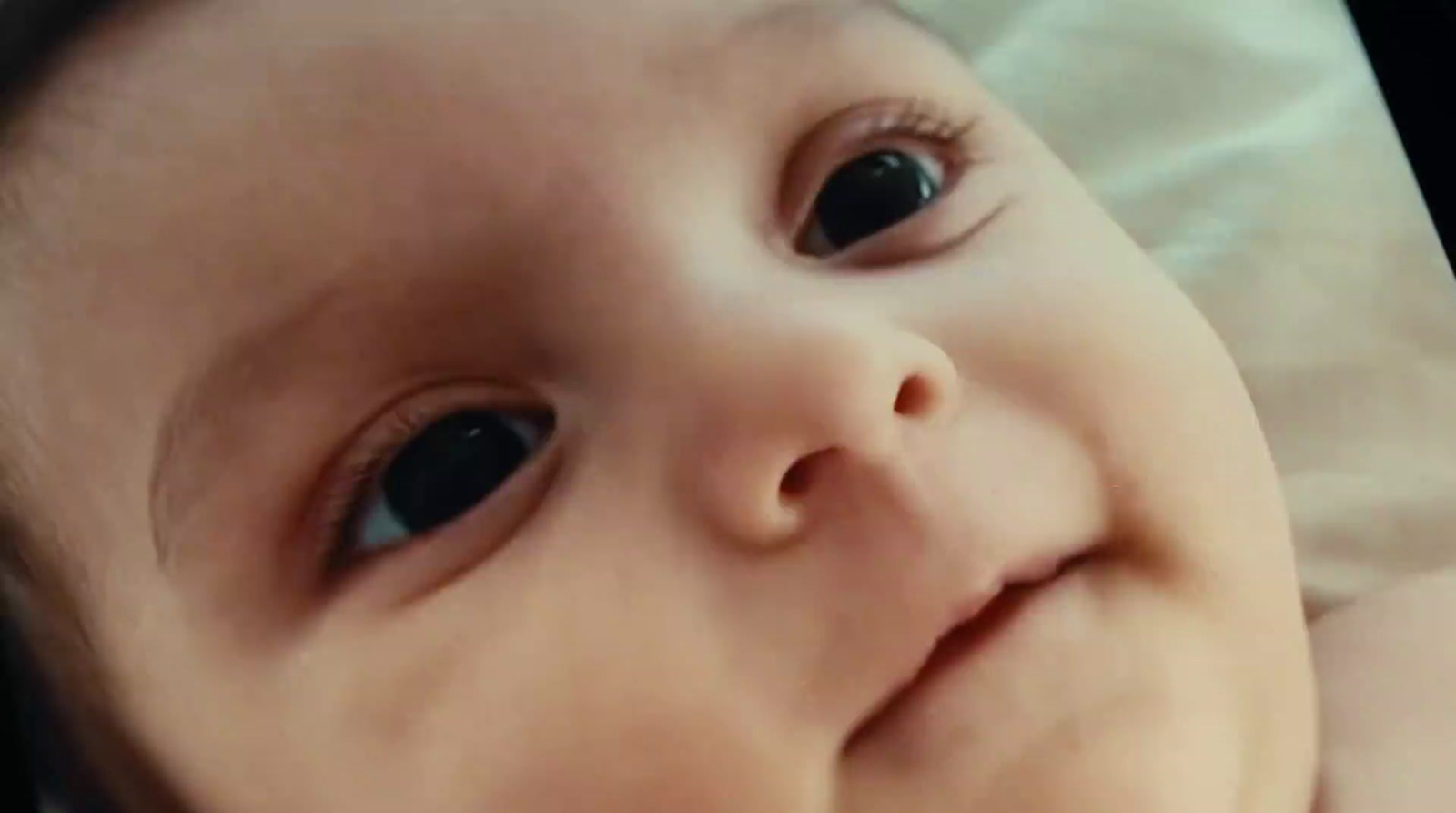 a close up of a baby with a tie on