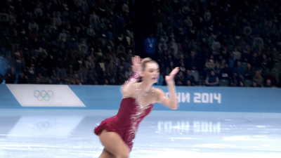 a female figure skating on a ice rink