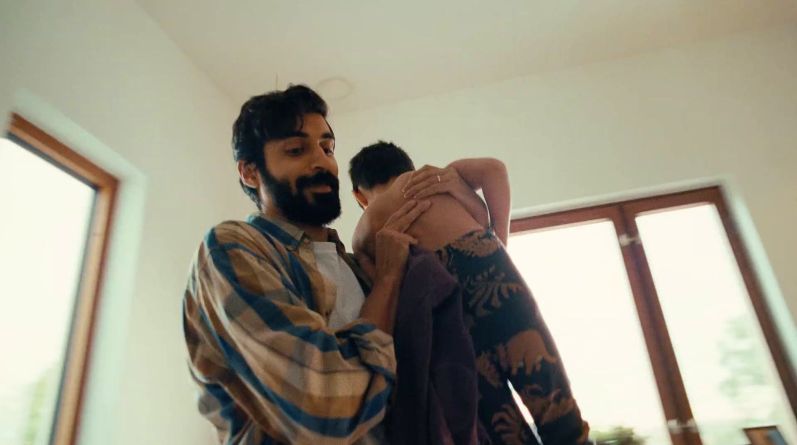 a man standing next to a woman in a room