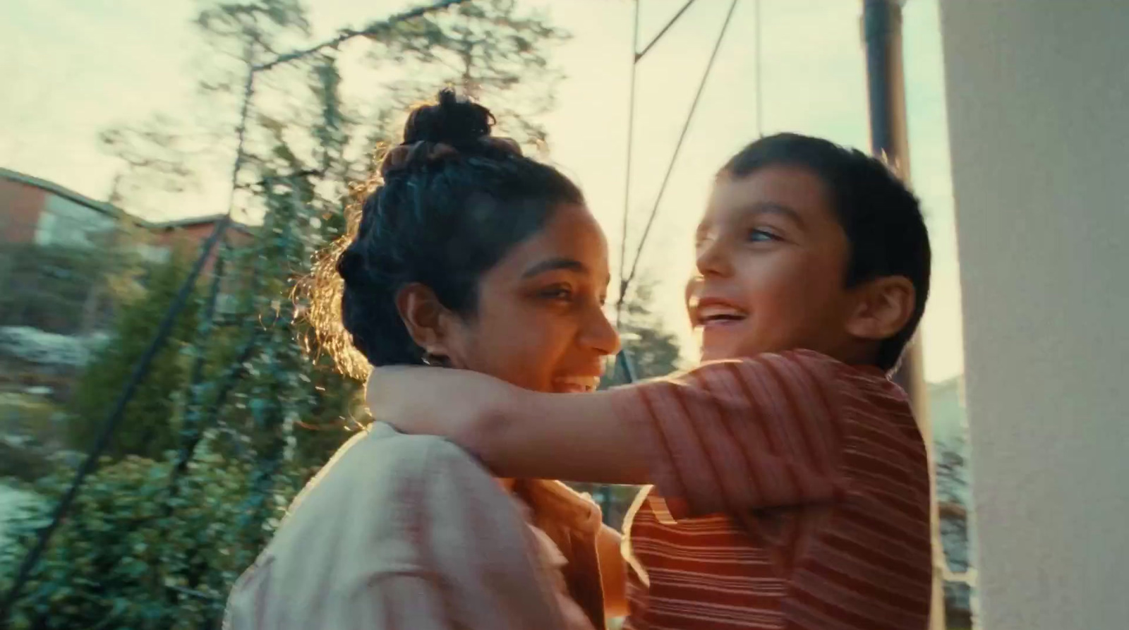 a woman and a boy standing next to each other