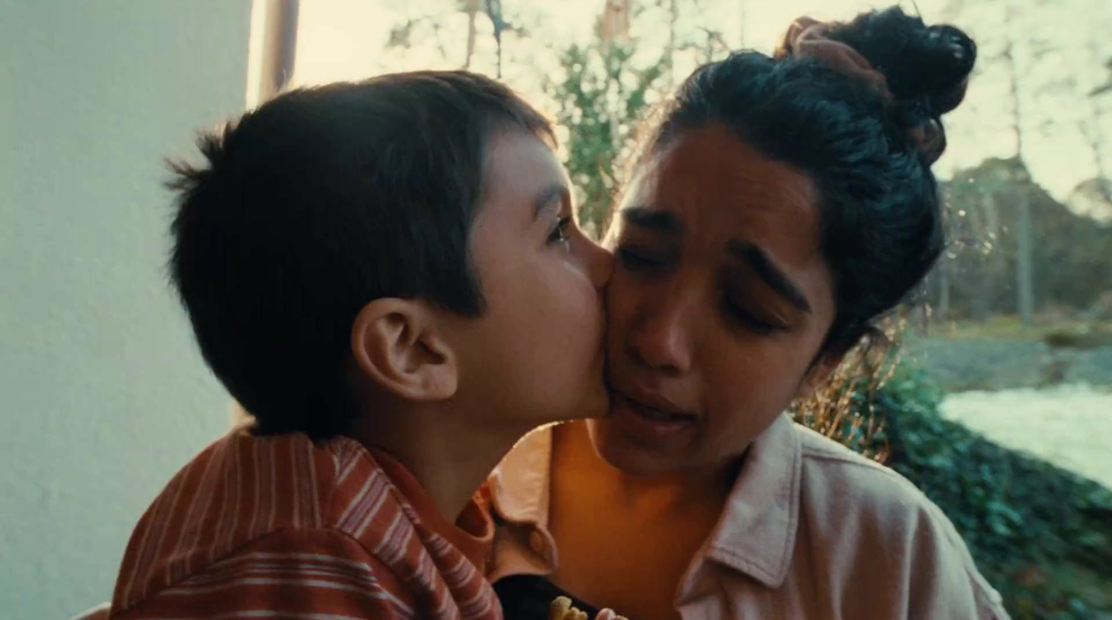 a boy and a girl kissing each other