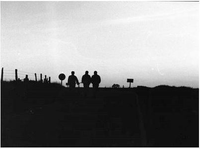 a group of people standing on top of a hill