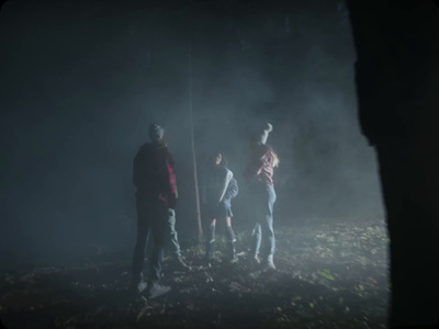 a group of people standing on top of a grass covered field