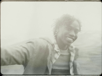 a black and white photo of a man smiling