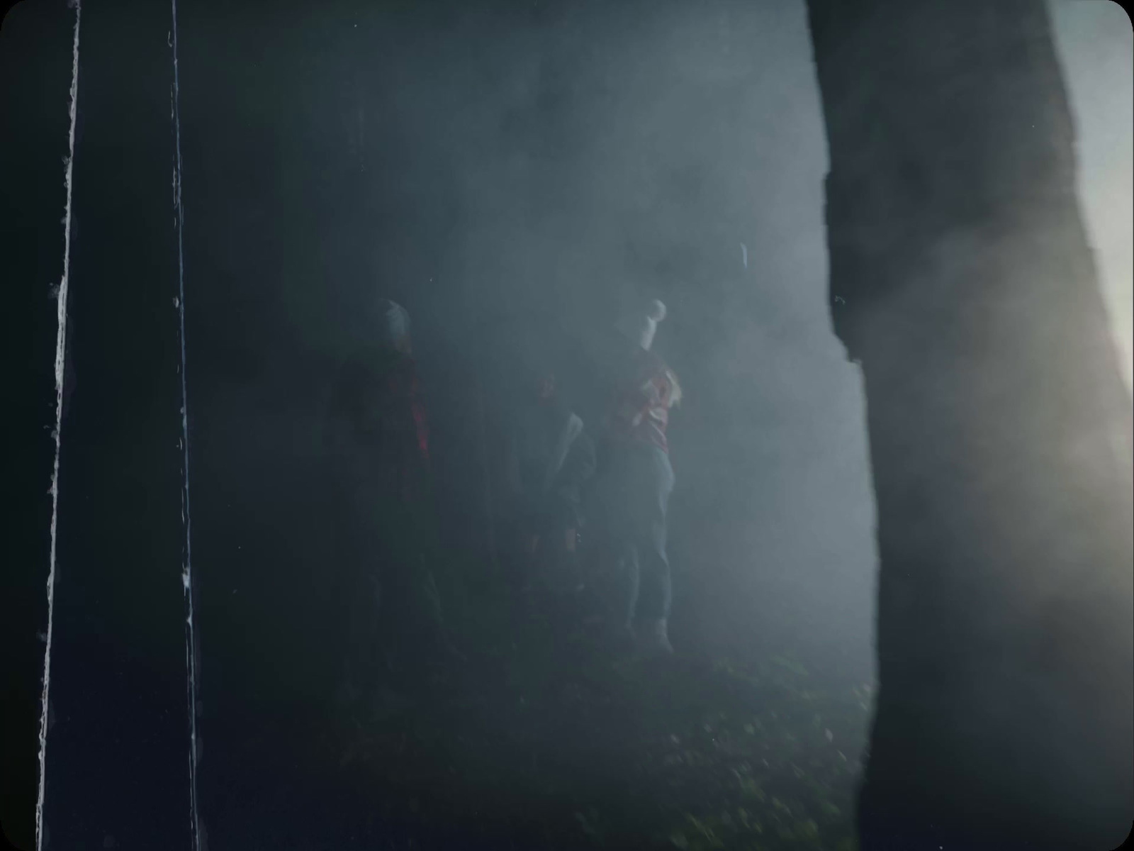 a group of people standing next to each other in the dark