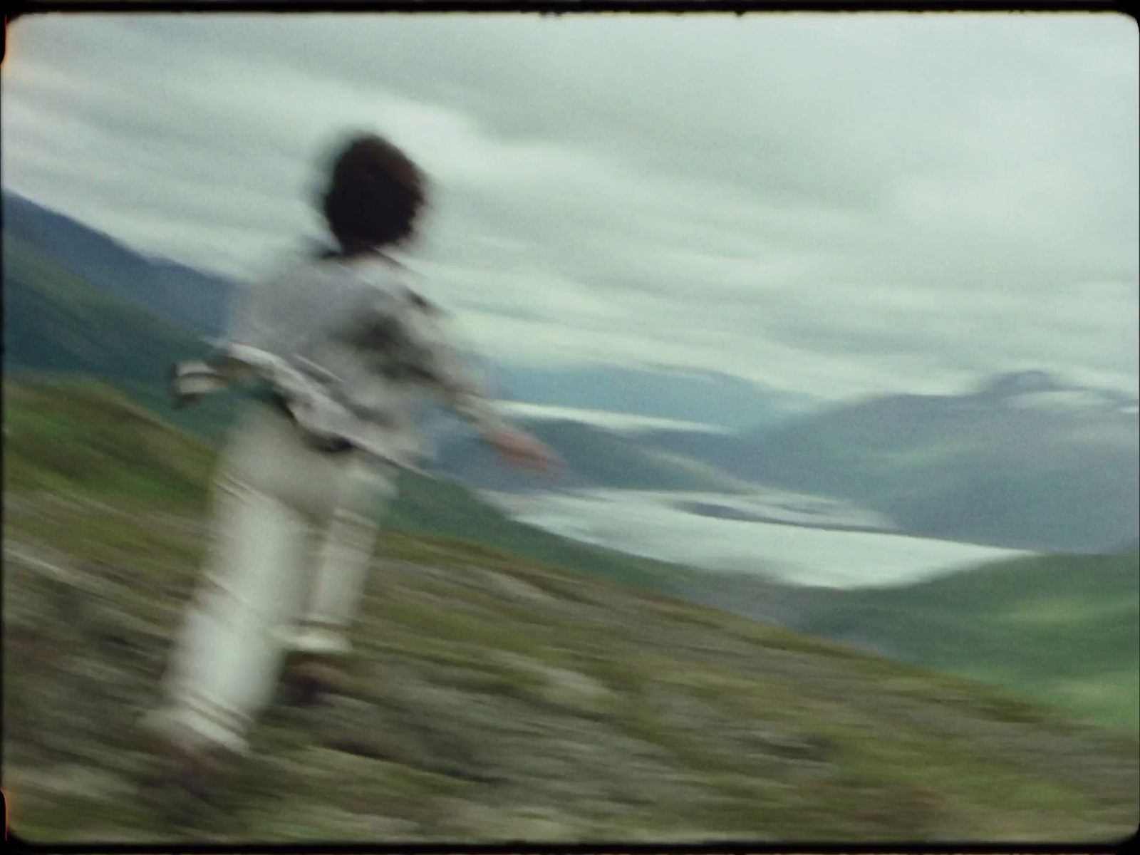 a blurry photo of a person standing on a hill