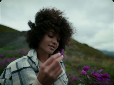 a woman standing in a field of purple flowers