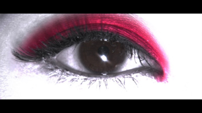 a woman's eye with red and white makeup