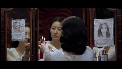 a woman in a white dress is looking in a mirror