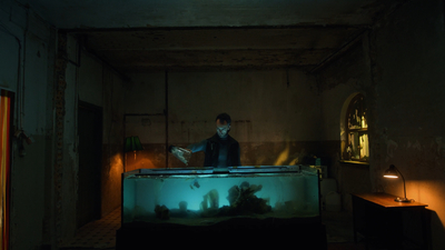 a man standing in front of a fish tank