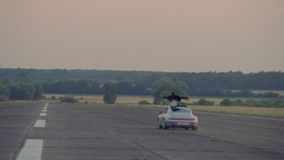 a car driving down a road with a person on top of it