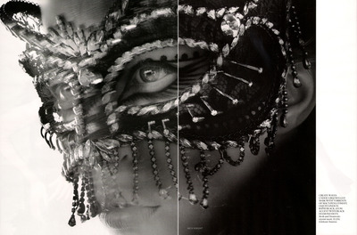 a black and white photo of a woman wearing a mask