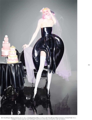 a woman in a latex outfit sitting on a chair next to a cake