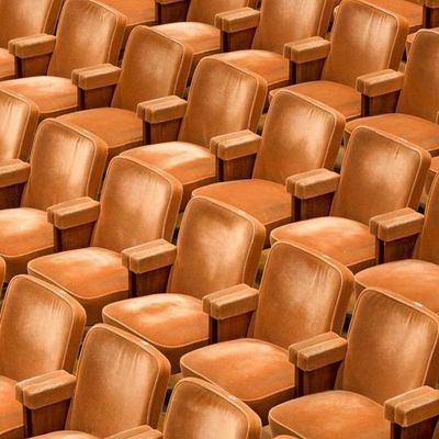 a row of brown chairs sitting next to each other