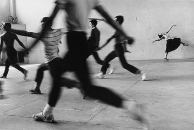 a black and white photo of a group of people dancing