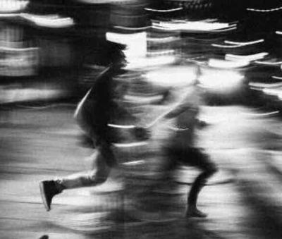 a blurry photo of a person running down a street