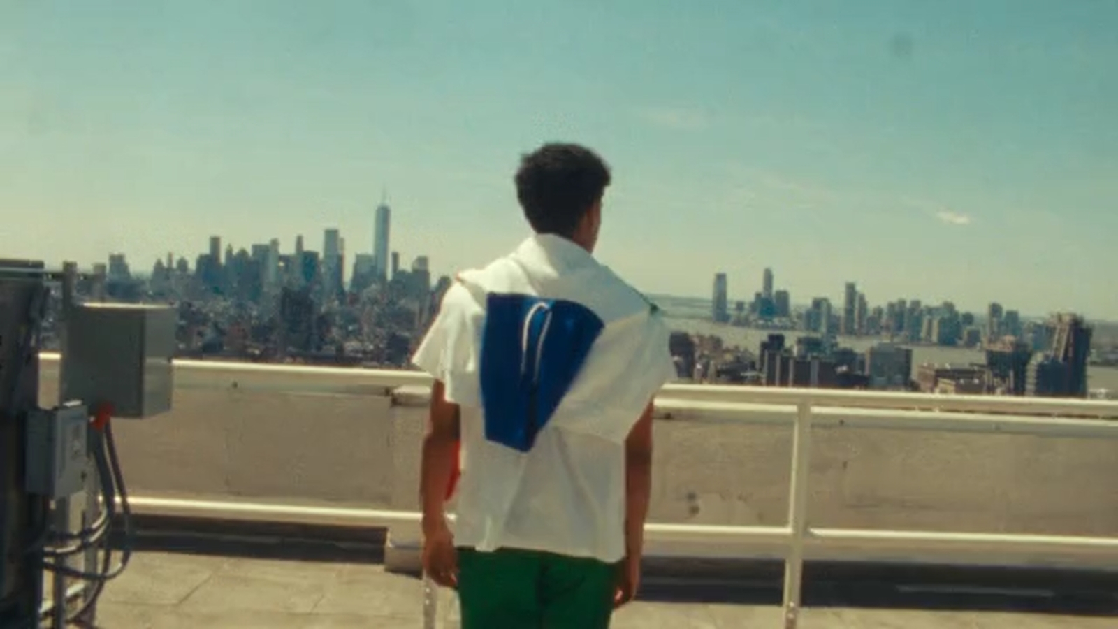 a man standing on top of a roof with a cell phone