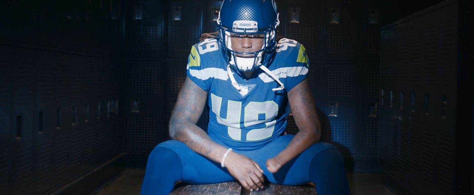 a football player sitting in a locker room