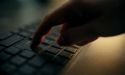 a close up of a person typing on a keyboard