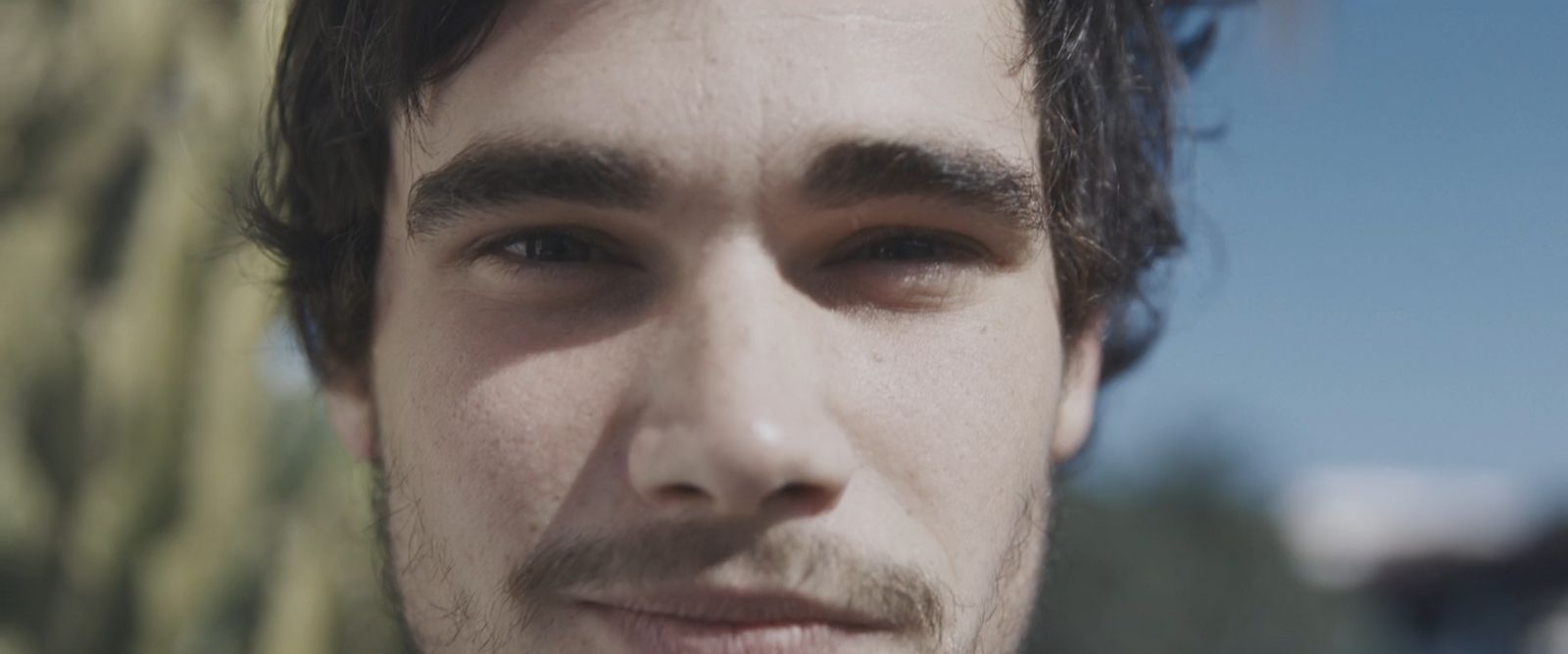 a close up of a person wearing a suit and tie